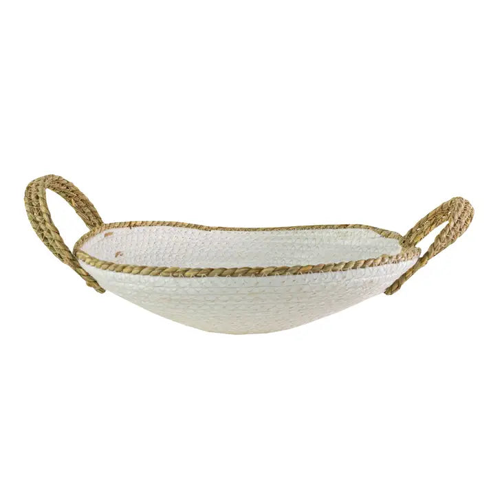 A hand-woven large decorative bowl made of white and natural seagrass with two rope handles.